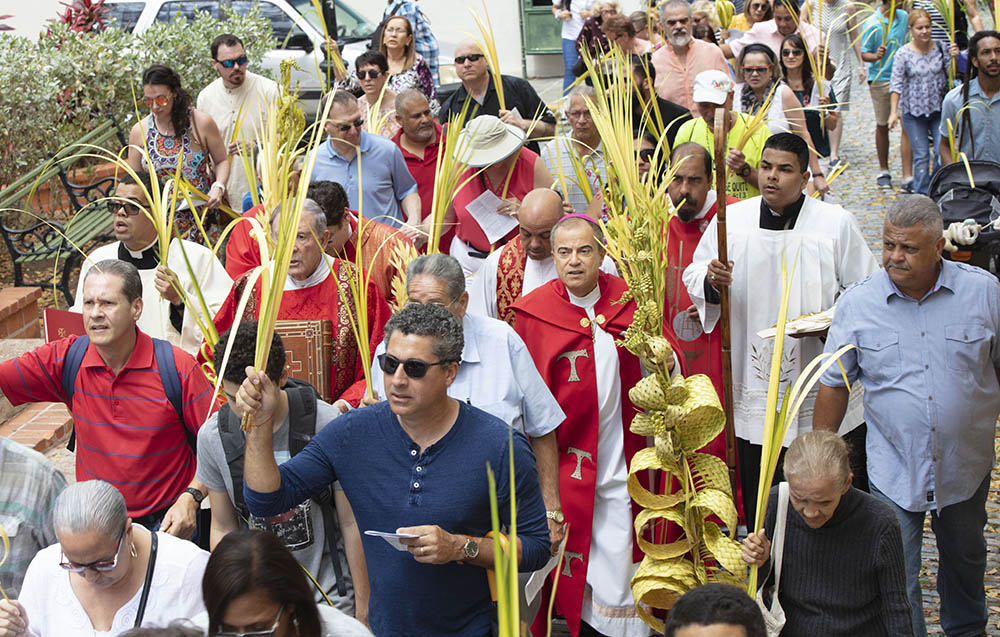Archbishop Roberto González Nieves of San Juan, Puerto Rico, center right, leads the Palm Sunday procession to the cathedral to celebrate Mass April 14, 2019. (CNS/Octavio Duran)