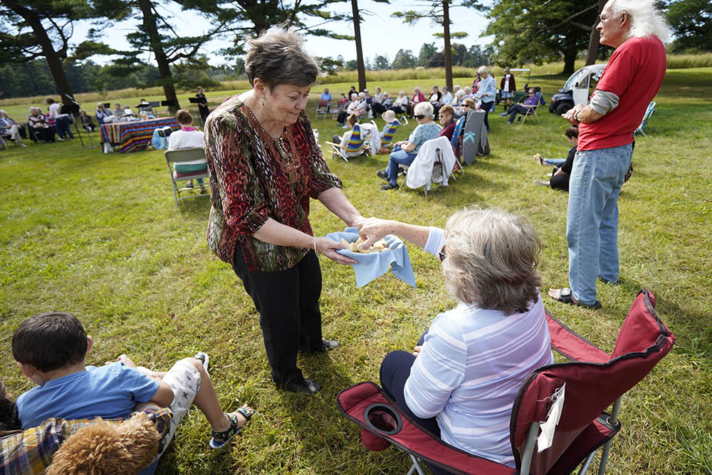 Sr. Maryellen Kane, executive director of the U.S. Federation of the Sisters of St. Joseph, distributes organic bread during a prayer service marking the Season of Creation at the motherhouse of the Sisters of St. Joseph of Brentwood, New York, Oct. 3, 2021. (CNS/Gregory A. Shemitz)