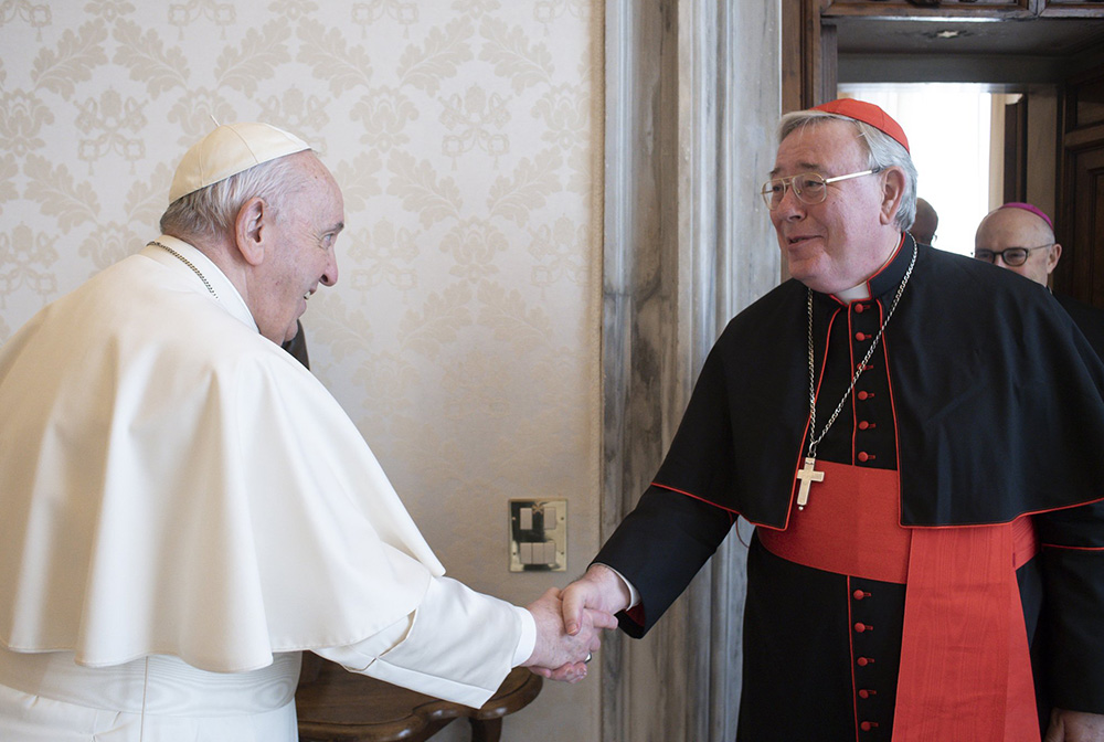 Pope Francis greets Cardinal Jean-Claude Hollerich of Luxembourg during the cardinal's ad limina visit to the Vatican Feb. 14, 2022. (CNS/Vatican Media)