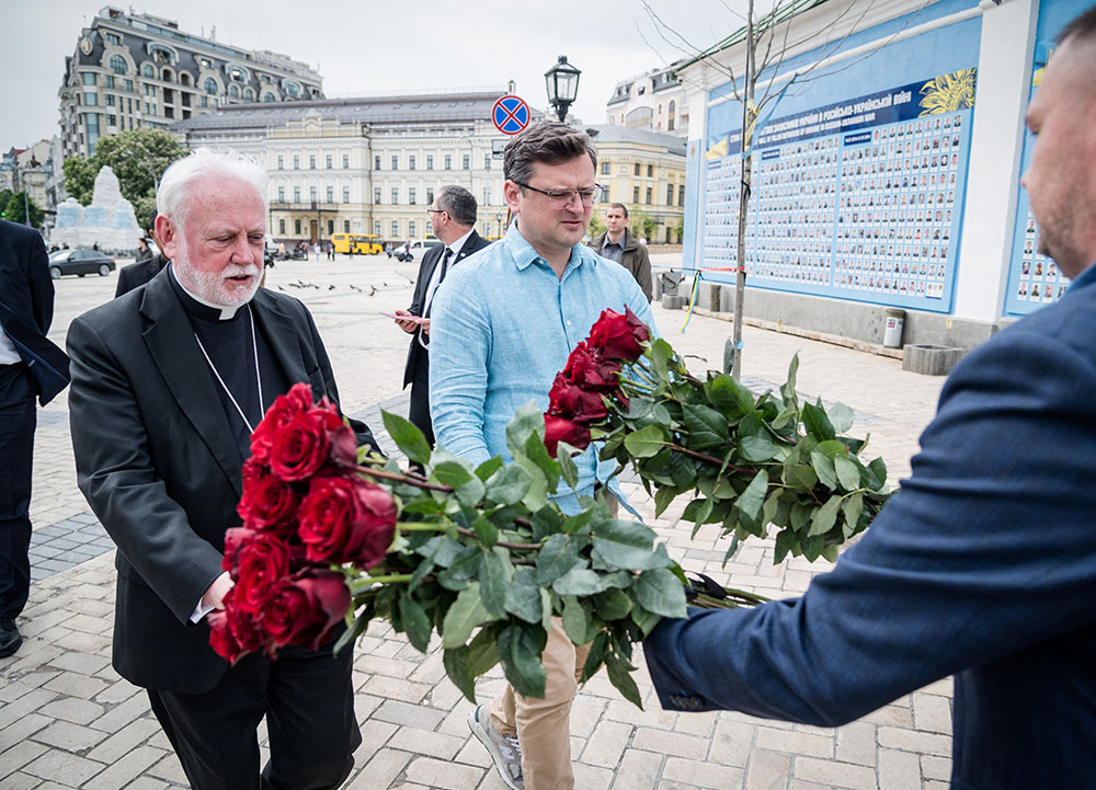 Archbishop Paul Gallagher, Vatican foreign minister, and Dmytro Kuleba, Ukraine's foreign minister, visit the Wall of Remembrance to pay tribute to killed Ukrainian soldiers, in Kyiv, Ukraine, May 20, 2022. Gallagher was meeting with church leaders, displaced people and government officials in Ukraine. (CNS/Handout via Reuters/Ukrainian Foreign Ministry Press Service)