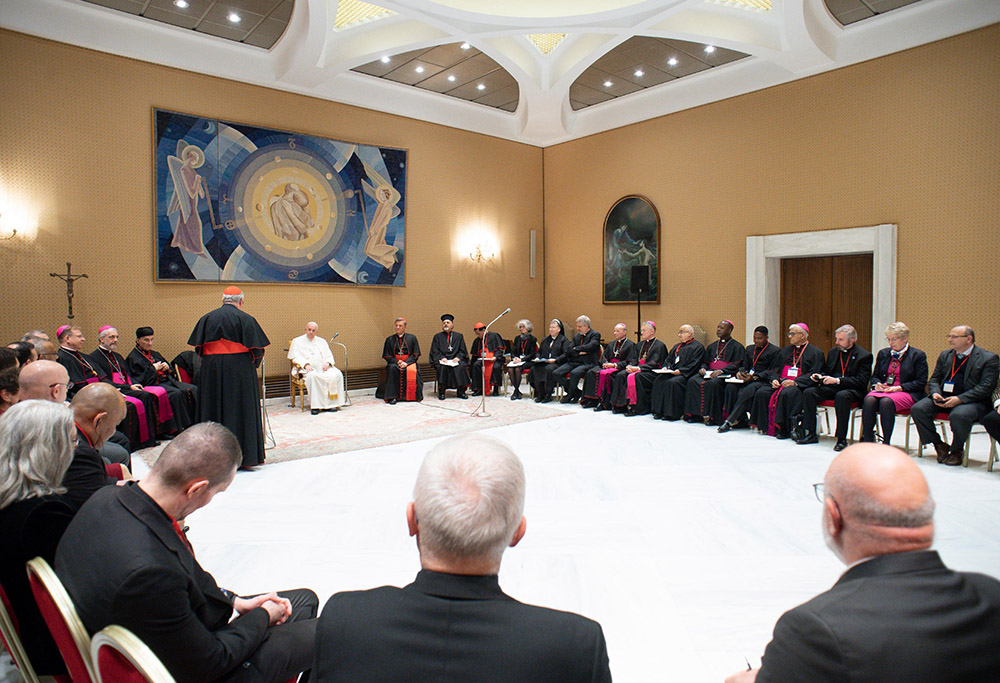 Pope Francis listens as Cardinal Jean-Claude Hollerich of Luxembourg, relator general of the Synod of Bishops, speaks during a meeting with the presidents and coordinators of the regional assemblies of the Synod of Bishops at the Vatican Nov. 28, 2022. (CNS/Vatican Media)