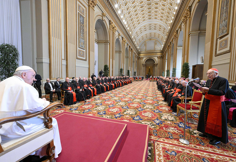 Pope Francis listens as Cardinal Giovanni Battista Re, dean of the College of Cardinals, offers best wishes for Christmas on behalf of the cardinals and top officials of the Roman Curia during a gathering Dec. 22, 2022, in the Vatican's Hall of Blessings. (CNS/Vatican Media)