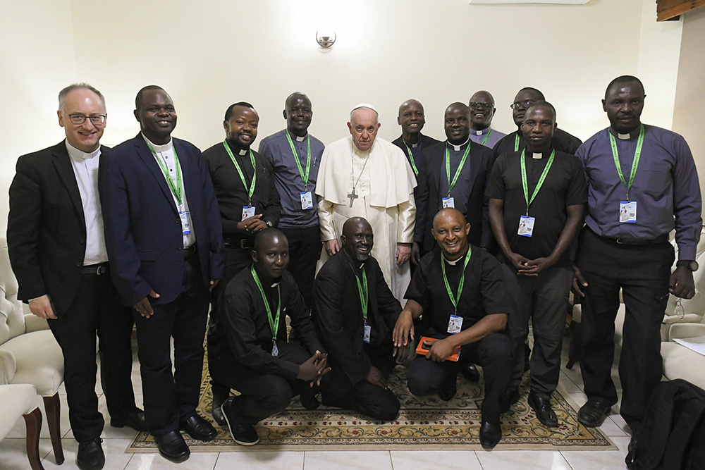 Pope Francis poses for a photo with Jesuits working in South Sudan and with Jesuit Fr. Antonio Spadaro (left), editor of La Civiltà Cattolica, in Juba Feb. 4, 2023. The Jesuit magazine published a transcript of the pope's conversation with the priests Feb. 16. (CNS/Vatican Media)