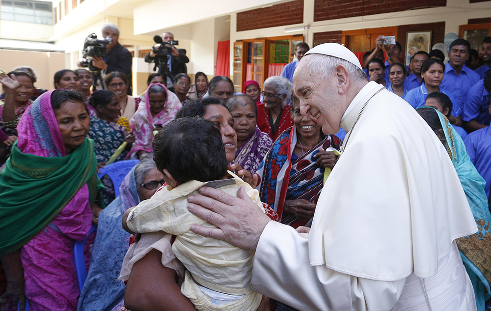 Pope Francis greets people as he visits the Mother Teresa House in the Tejgaon neighborhood in Dhaka, Bangladesh, Dec. 2, 2017. (CNS/Paul Haring)