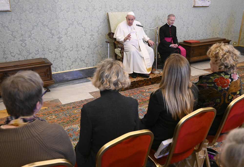 Pope Francis speaks with staff members of the Vatican newspaper's monthly insert dedicated to women during an audience March 4 at the Vatican. The supplement, "Women, church, world," was launched in May in 2012. The pope praised and encouraged them in their work, saying "it is not a kind of clerical feminism of the pope, no! It is opening the door to a reality, a reflection that goes deeper." (CNS/Vatican Media)