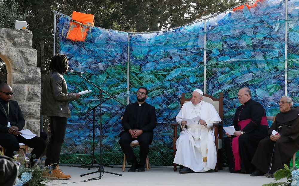 Pope Francis meets with migrants at the John XXIII Peace Lab's Center for Migrants in Hal Far, Malta, April 3, 2022. The backdrop was built with plastic bottles and life vests pulled from the sea. (CNS photo/Paul Haring)