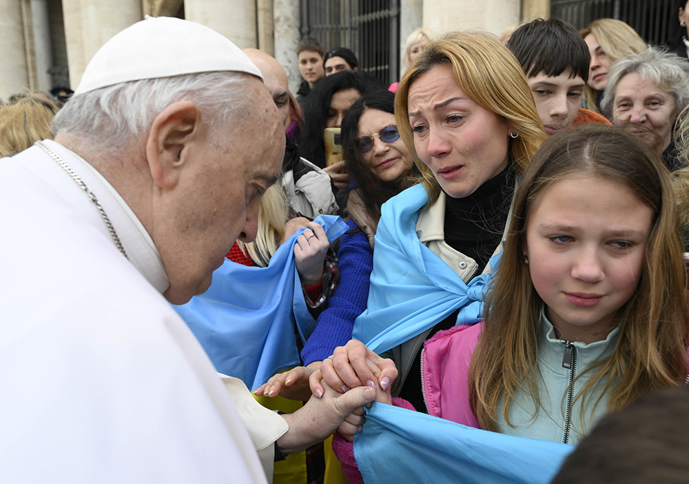 Pope Francis greets Ukrainian refugees after his weekly general audience in St. Peter's Square at the Vatican March 8, 2023. (CNS/Vatican Media)