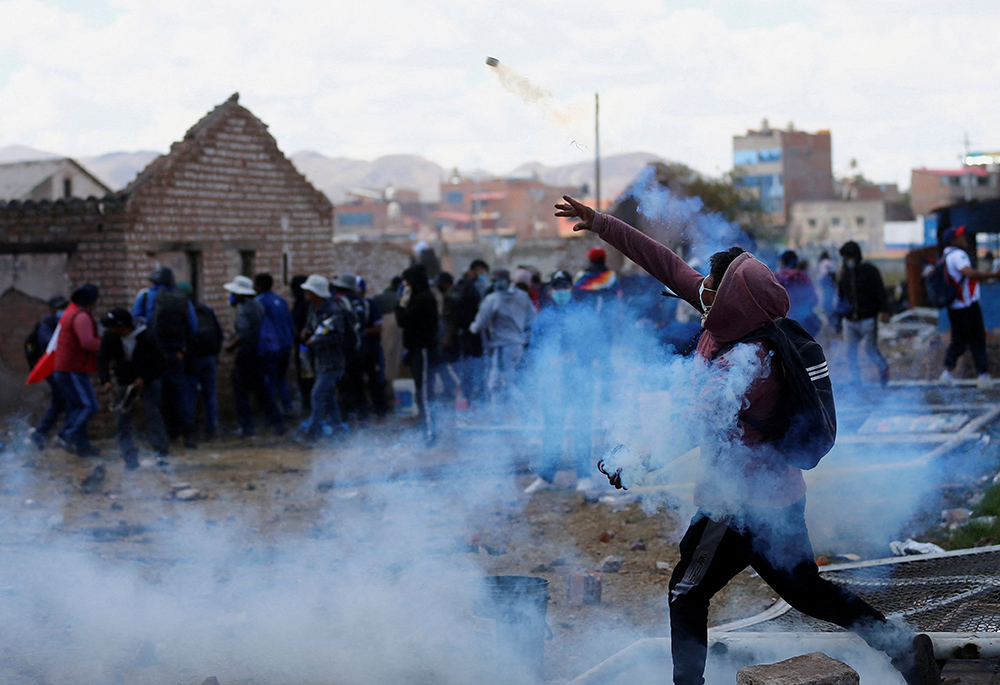 Demonstrators clash with security forces near the Juliaca, Peru, airport during a Jan. 9 protest demanding early elections and the release of jailed former Peruvian President Pedro Castillo. (OSV News/Reuters/Hugo Courotto)