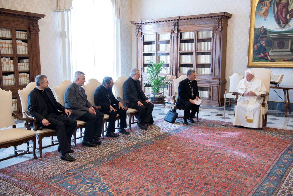 Pope Francis meets with members of the preparatory commission for the general assembly of the Synod of Bishops in the library of the Apostolic Palace at the Vatican March 16, 2023. Pictured to the left of the pope are: Cardinal Mario Grech, secretary-general of the Synod; Jesuit Father Giacomo Costa, commission coordinator; Bishop Daniel E. Flores of Brownsville, Texas; Father Dario Vitali; and Msgr. Tomasz Trafny. (CNS photo/Vatican Media)