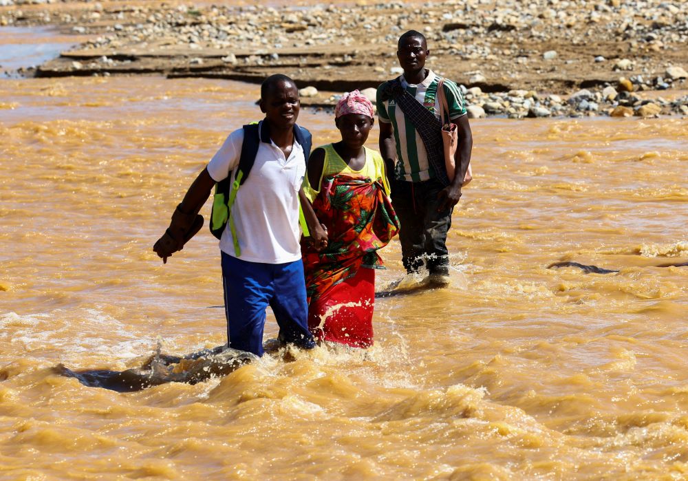 Locals cross a flooded area in Muloza, Malawi, March 17, 2023, in the aftermath of Cyclone Freddy. (OSV News/Reuters/Esa Alexander)
