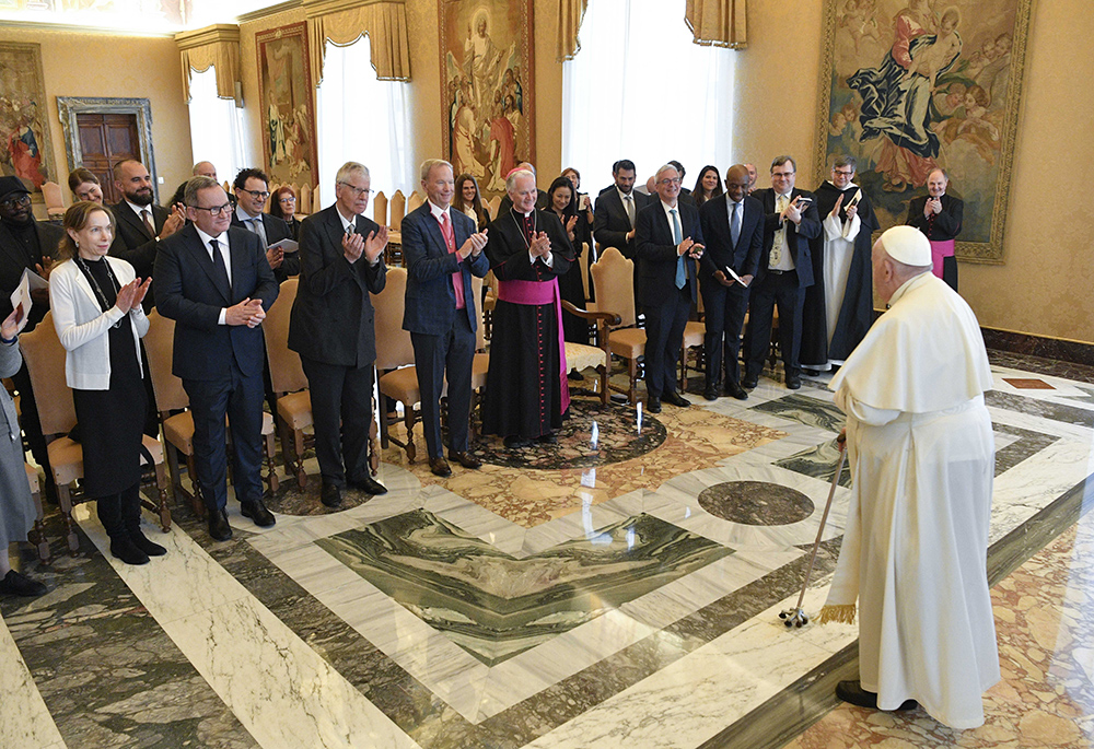 Pope Francis meets leaders from the tech industry March 27 at the Vatican. He called for an "ethical and responsible" development of artificial intelligence. Over the previous weekend, an image of Francis sporting a white puffer jacket went viral online; but the image was fake, generated by a man who used AI to produce it. (CNS/Vatican Media)