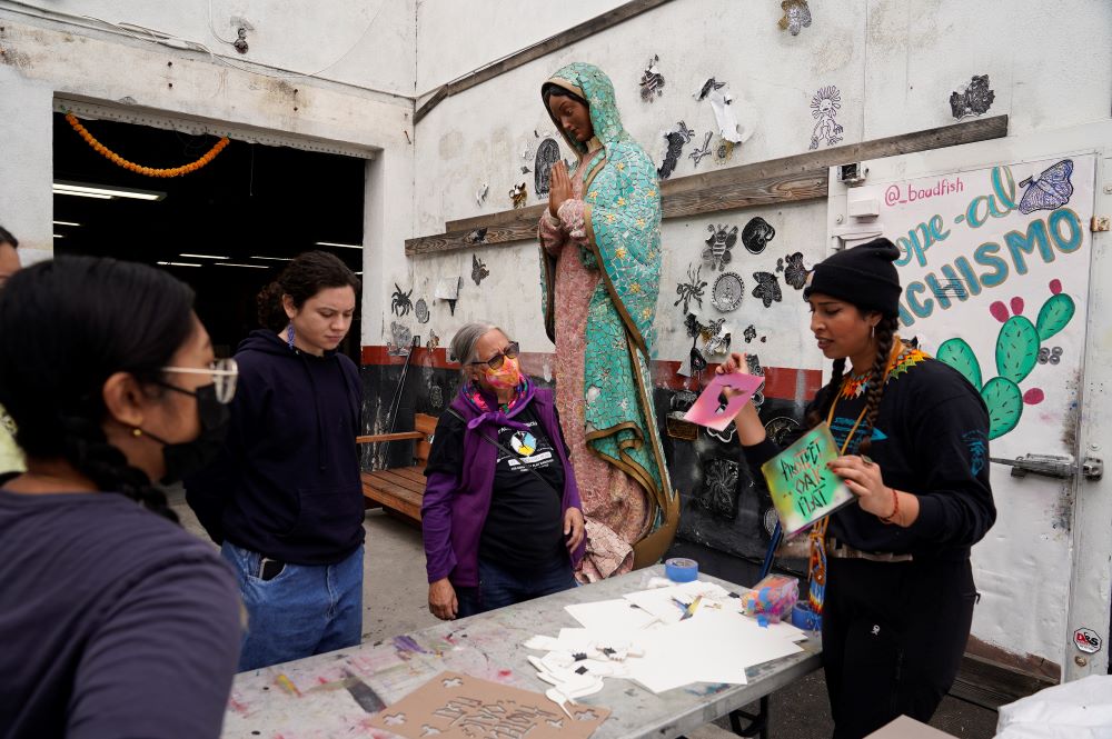 Members of the Apache Stronghold group who traveled from Arizona paint protest signs at Self Help Graphics & Art in the Los Angeles neighborhood of Boyle Heights.