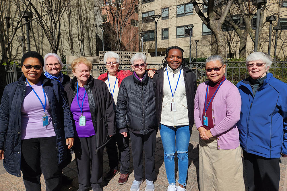 A group of eight Dominican sisters from four countries who participated in Commission on the Status of Women events pose for a photograph near the United Nations in New York City. (GSR photo/Chris Herlinger)