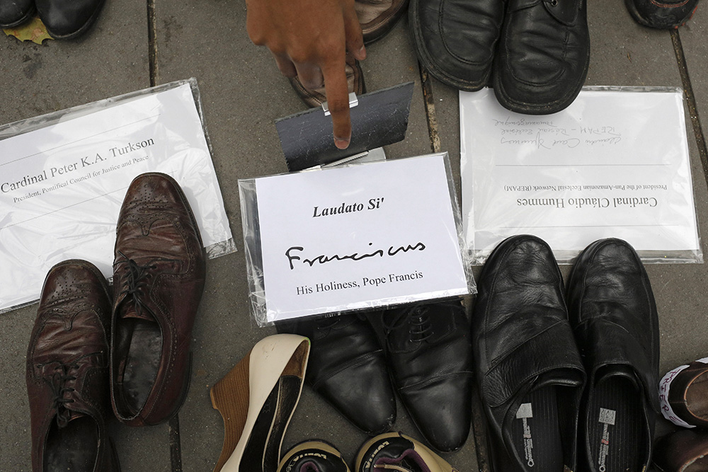 Pope Francis' shoes are seen in the middle of hundreds of pairs of shoes displayed at the Place de la Republique in Paris on Nov. 29, 2015, as part of a rally for climate action ahead of the COP21 U.N. climate conference that began the next day. (AP/Laurent Cipriani)