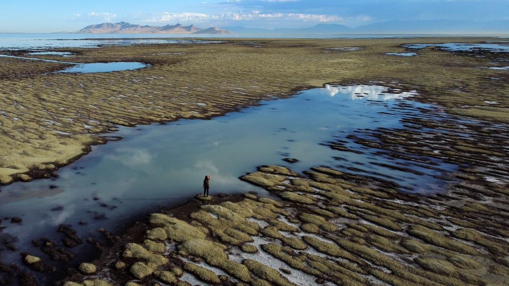 State of Utah Department of Natural Resources park ranger Angelic Lemmon walks across reef-like structures called microbialites, exposed by receding waters at the Great Salt Lake on Wednesday, Sept. 28, 2022, near Salt Lake City.