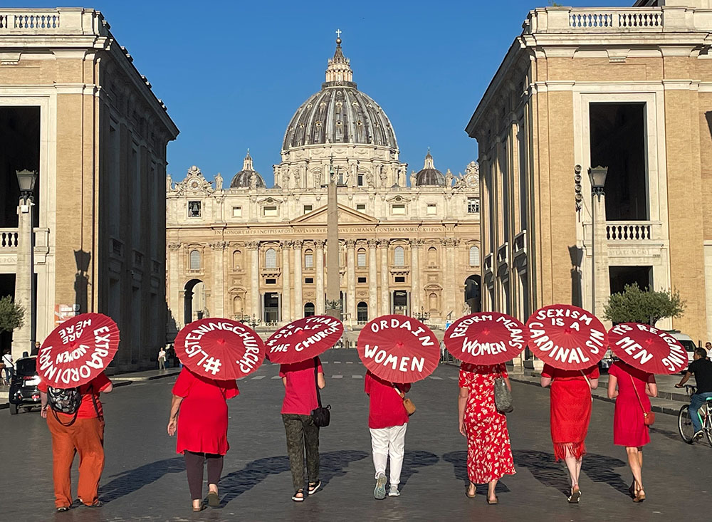 Women's ordination advocates walk toward St. Peter's Square at the Vatican as part of a witness on Aug. 29, 2022. (NCR photo/Christopher White)