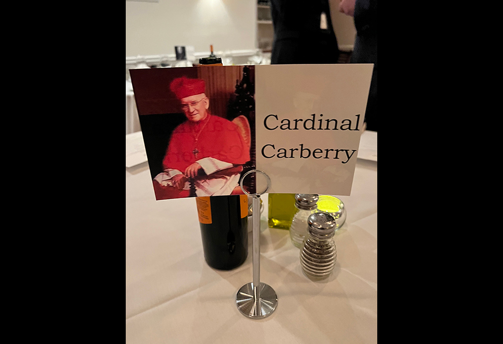 A table number featuring the late Cardinal John Carberry is pictured. Tables were named for cardinals during a group dinner that was part of a two-day ecclesial gathering March 3-4 at Boston College. (NCR photo/Brian Fraga)