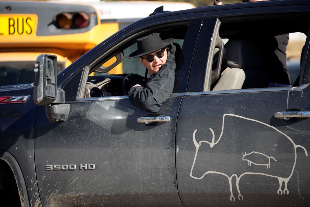Jason Baldes, of the Eastern Shoshone Tribe, backs up his pickup truck to position a trailer to pick up some of 35 Denver Mountain Park bison being transferred to representatives of four Native American tribes and one memorial council as they reintroduce the animals to tribal lands Wednesday, March 15, 2023, near Golden, Colo. (AP Photo/David Zalubowski)