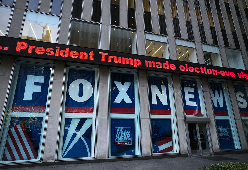 A headline about then-President Donald Trump is displayed outside Fox News studios in New York on Nov. 28, 2018. Documents in a defamation lawsuit illustrate pressures faced by Fox News journalists in the weeks after the 2020 presidential election. The network was on a collision course between giving its conservative audience what it wanted and reporting uncomfortable truths about then-President Donald Trump and his false fraud claims. (AP photo/Mark Lennihan, File)