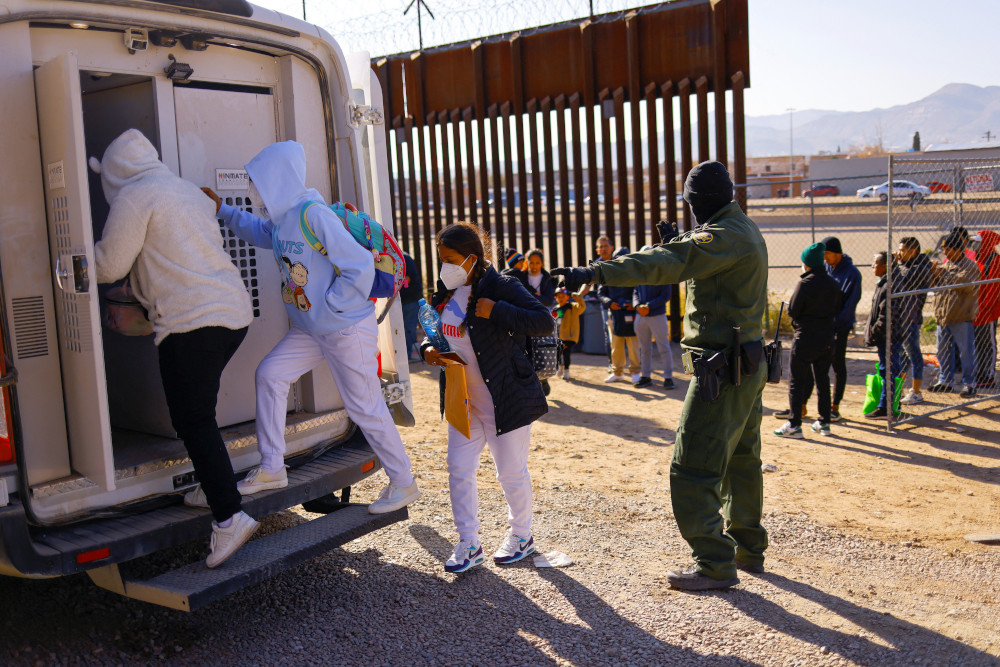 Migrants detained by U.S. Border Patrol agents after crossing into the United States from Mexico to request asylum get in a vehicle to be transferred to a detention center in El Paso Texas, Dec. 19, 2022. The Biden administration is weighing the reinstatement of a family detention policy for migrants who cross the U.S. border without legal authorization. (OSV News/Reuters/Jose Luis Gonzalez)