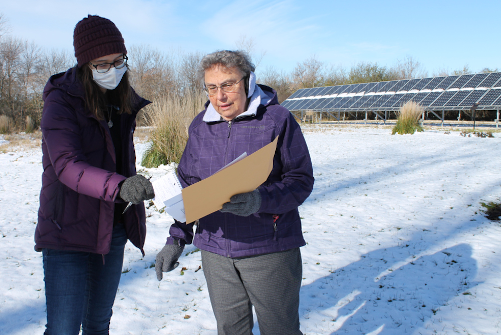University of Wisconsin-Green Bay student Stephanie Farrey, left, discusses hydrology efforts at St. Francis Convent with Sr. Rose Jochmann, community president of the Sisters of St. Francis of the Holy Cross. The congregation's retention ponds, dry pond and swales are examples of proper water storage and permeability that prevent runoff from polluting the Bay of Green Bay. (Renae Bauer/Sisters of St. Francis of the Holy Cross)