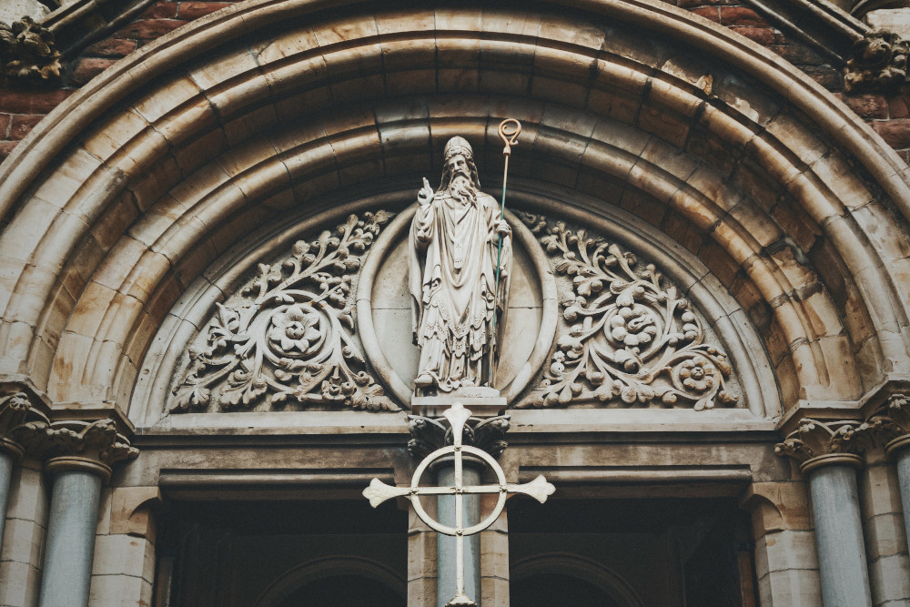 A statue of St. Patrick above the entrance to St. Patrick's Roman Catholic Church in Belfast's Cathedral Quarter in County Antrim (K. Mitch Hodge/Unsplash)