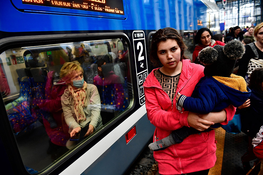 Refugees fleeing Russia's invasion of Ukraine walk through the Nyugati railway station in Budapest, Hungary, Feb. 28, 2022. (CNS/Reuters/Marton Monus)