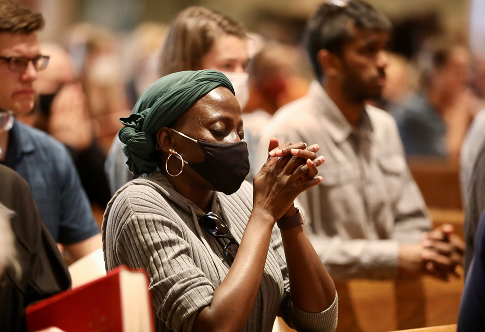People in Washington pray at the Cathedral of St. Matthew the Apostle on Good Friday, April 15, 2022, during the celebration of the Liturgy of the Lord's Passion. (CNS/Catholic Standard/Andrew Biraj)