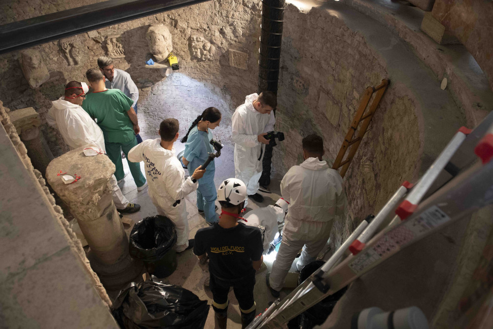 Workers inspect an ossuary at the Teutonic Cemetery at the Vatican in this July 20, 2019, file photo. The ossuary was inspected in the hope of finding the missing remains of a German princess and duchess and possibly the remains of Emanuela Orlandi, who disappeared in 1983. (CNS photo/Vatican Media) 