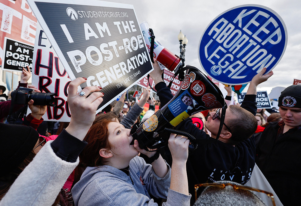Supporters of legal abortion and pro-life demonstrators hold signs outside the U.S. Supreme Court during the annual March for Life Jan. 20, 2023, in Washington, for the first time since the U.S. Supreme Court overturned the Roe v. Wade abortion decision. (OSV News/Reuters/Jonathan Ernst)