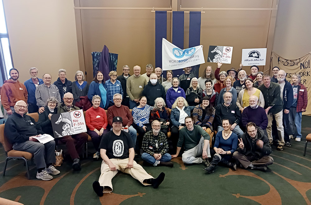 Participants in the Midwest Catholic Worker Faith and Resistance Retreat, held in Madison, Wisconsin, the last weekend in March, pose for a group photo. (NCR photo/Theodore Kayser)