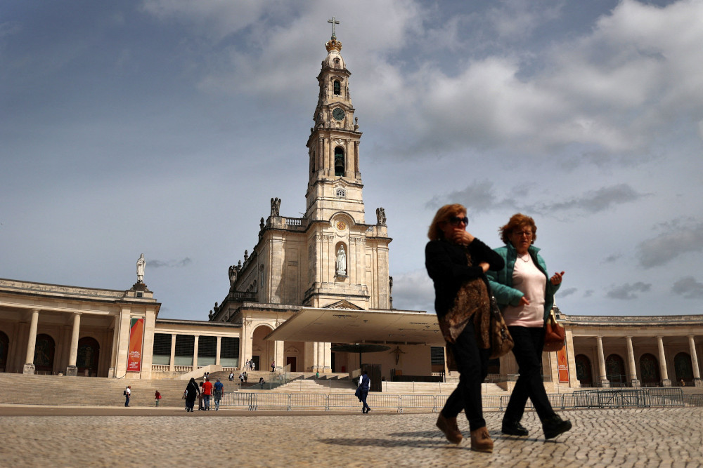 Women walk at the Marian shrine of Fatima in central Portugal March 30, ahead of Holy Week celebrations. (OSV News/Reuters/Pedro Nunes)