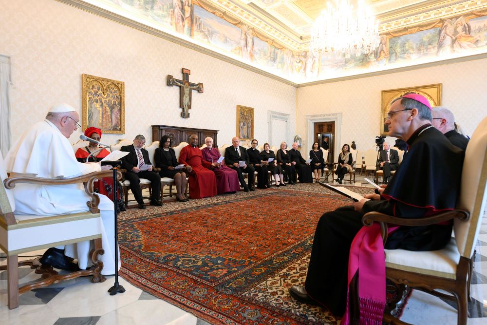 Pope Francis speaks to an interfaith delegation from England during an audience at the Vatican April 20, 2023. He told the group of religious and civic leaders from Manchester that the world needs new economic models that respect human dignity and protect creation. (CNS photo/Vatican Media)
