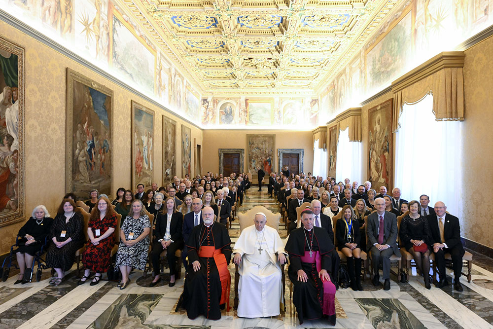 Pope Francis poses for a photo with members of the U.S.-based Papal Foundation during an audience at the Vatican April 21. The pope is seated between Boston Cardinal Sean O'Malley, chair of the foundation's board of trustees, and Bishop James Checchio of Metuchen, New Jersey. (CNS/Vatican Media)