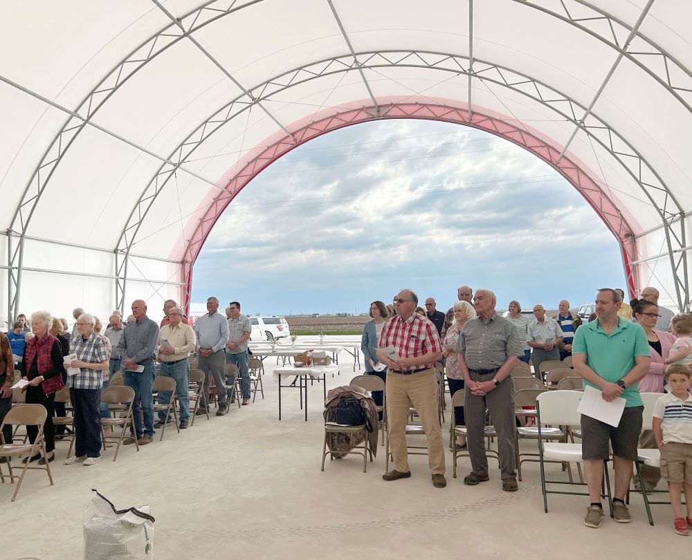 Worshippers pray in the hoop barn on the Pieper family farm in Donnellson, Iowa, during a Mass for the farm and the blessing of seeds April 15, 2023. Father Dan Dorau celebrated the Mass, whose inspiration comes from Catholic Rural Life. The four parishes he leads in Lee and Van Buren counties collaborated. (OSV News/The Catholic Messenger/Barb Arland-Fye)