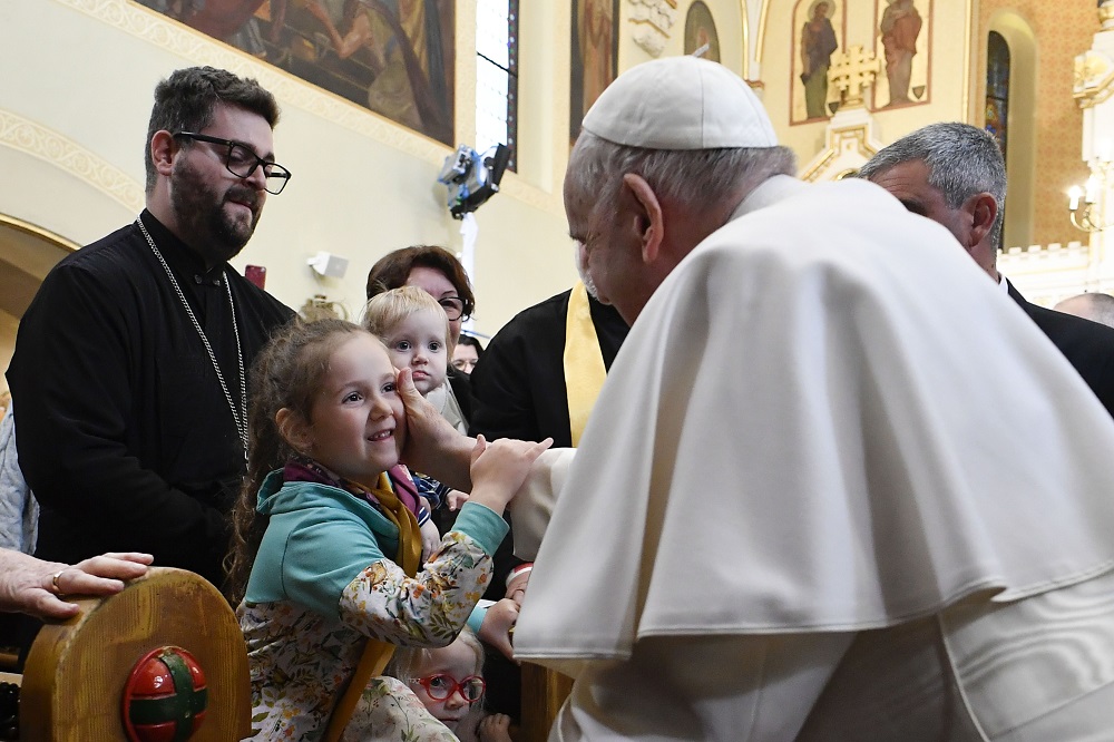 Pope Francis greets a family at the Eastern Catholic Protection of the Mother of God Church in Budapest, Hungary, April 29, 2023. 