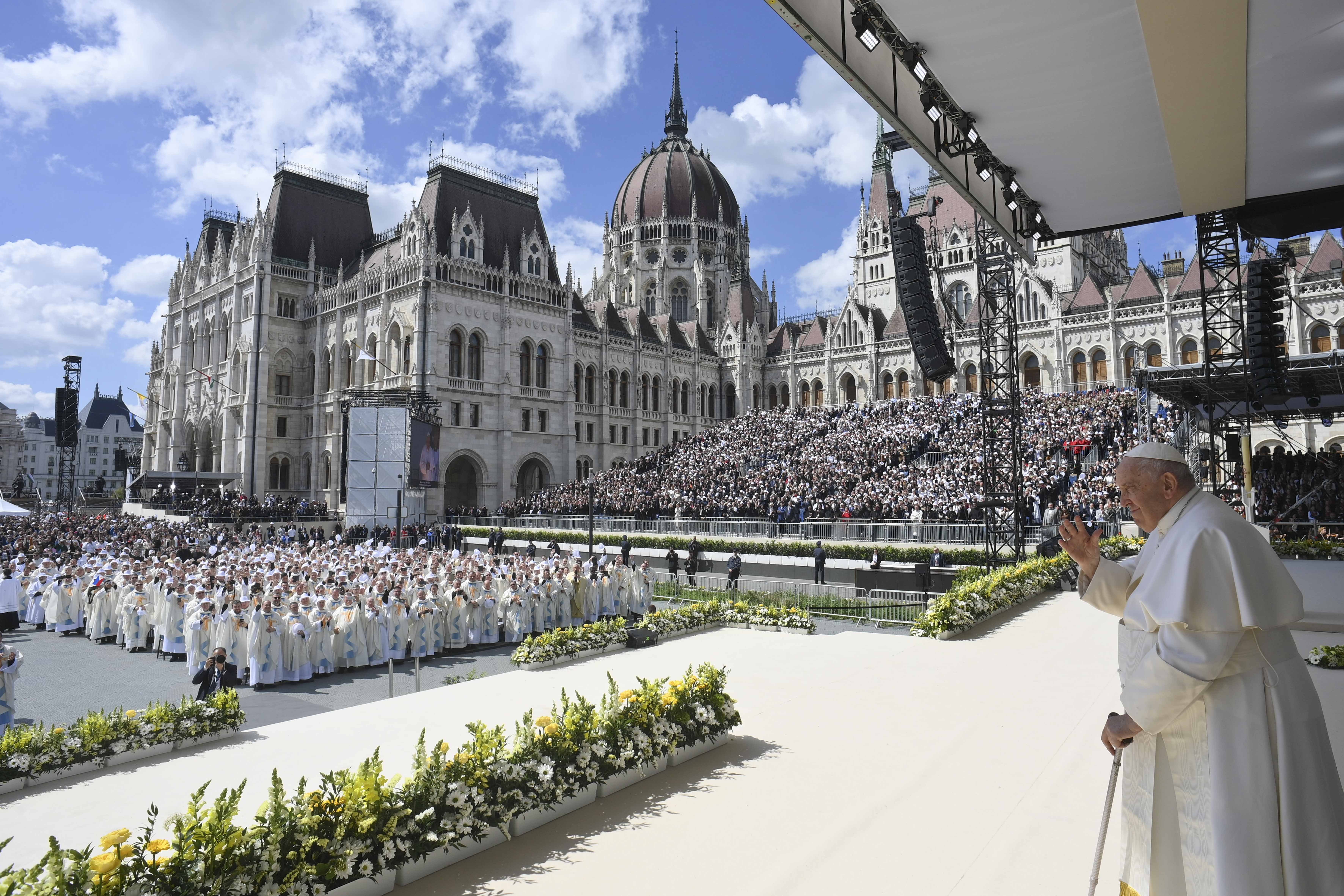 Pope Francis waves after celebrating Mass with about 50,000 people in Budapest's Kossuth Lajos Square, with the Hungarian Parliament building in the background, April 30, 2023. (CNS photo/Vatican Media)