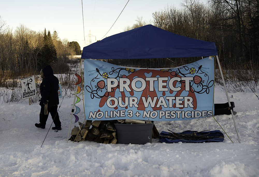 A "Protect Our Water No Line 3 + No Pesticides" sign protests Enbridge's Line 3 oil pipeline in Palisade, Minnesota, Dec. 28, 2020. (Wikimedia Commons/Lorie Shaull)