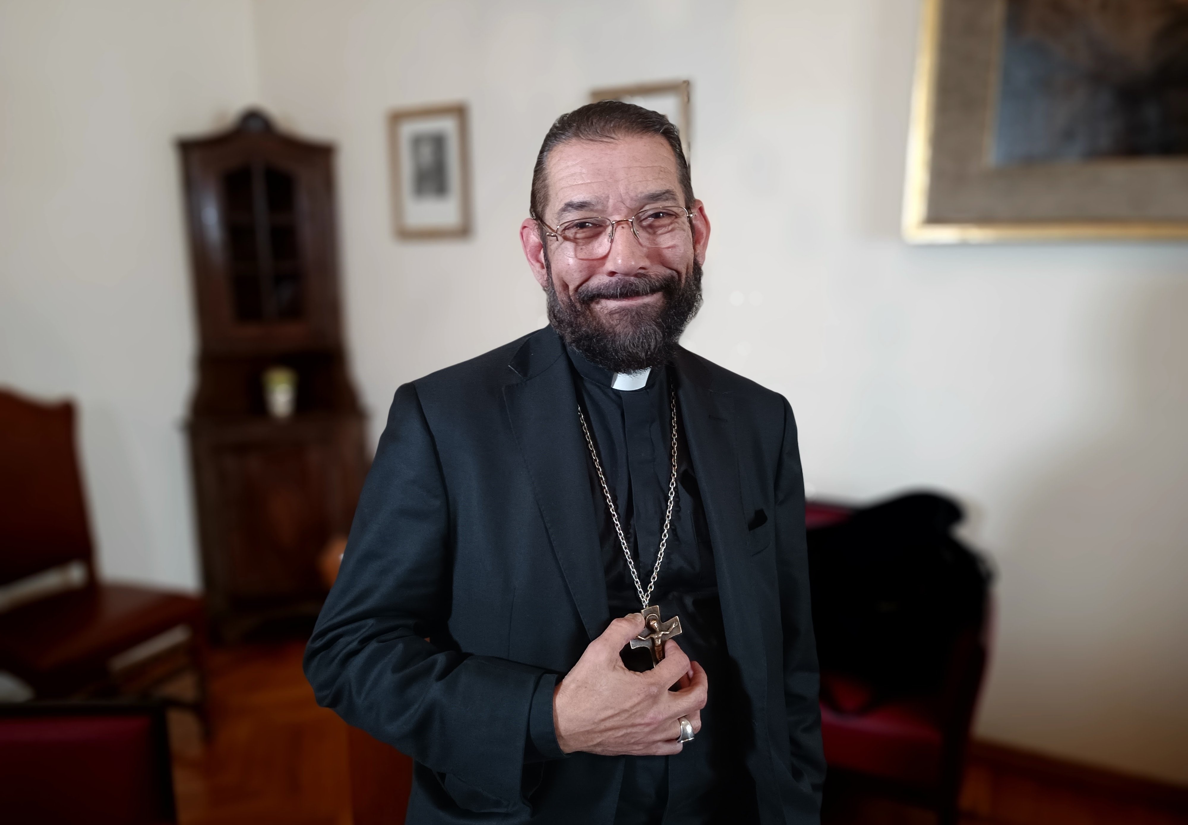 Bishop Daniel E. Flores of Brownsville, Texas, poses for a photo in the offices of the General Secretariat of the Synod at the Vatican April 12.