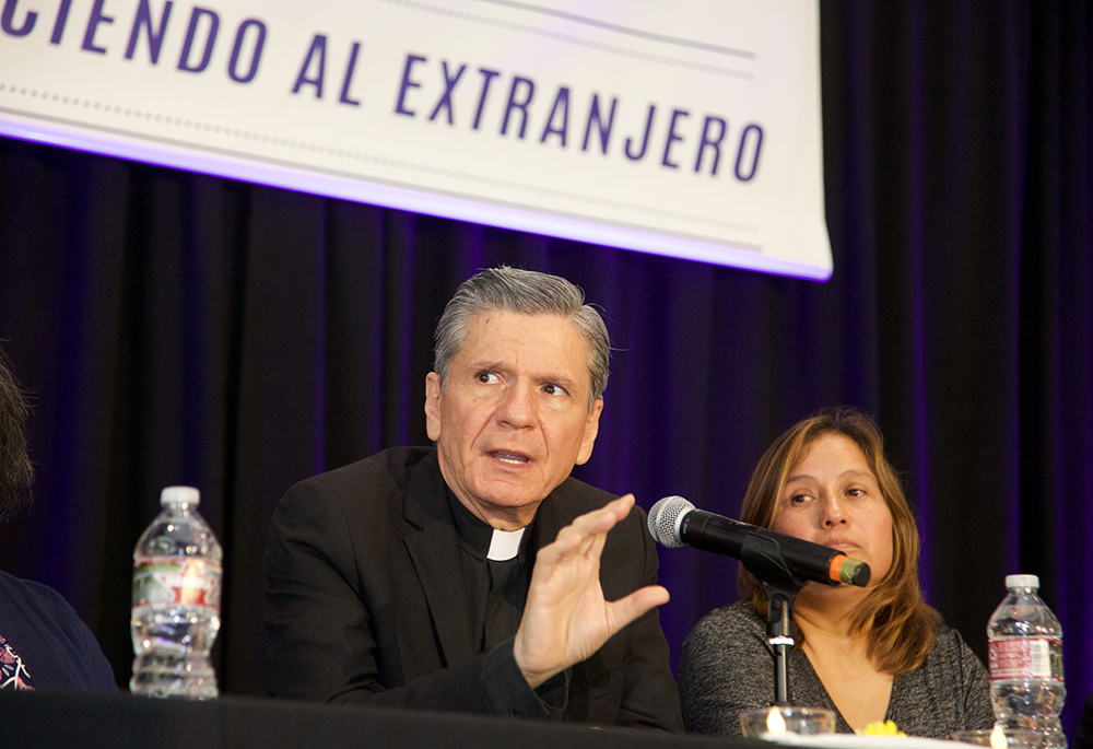 Archbishop Gustavo García-Siller of San Antonio speaks during a recent convocation to celebrate "Recognizing the Stranger," a parish-centered initiative funded by the U.S. bishops' Catholic Campaign for Human Development and implemented by the West/Southwest Industrial Areas Foundation, a network of community- and faith-based organizations. Seated beside the archbishop is Maricela Pineda, who participated in the program. (Courtesy of Alan Pogue)