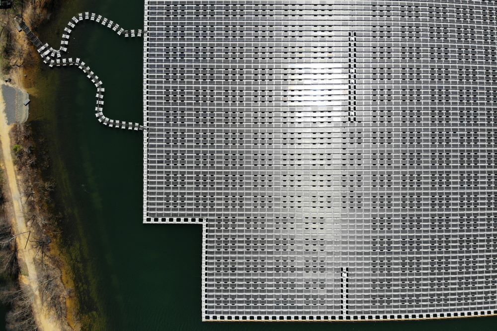 An array of solar panels float on top of a water storage pond in Sayreville, N.J., Monday, April 10, 2023. (AP Photo/Seth Wenig)