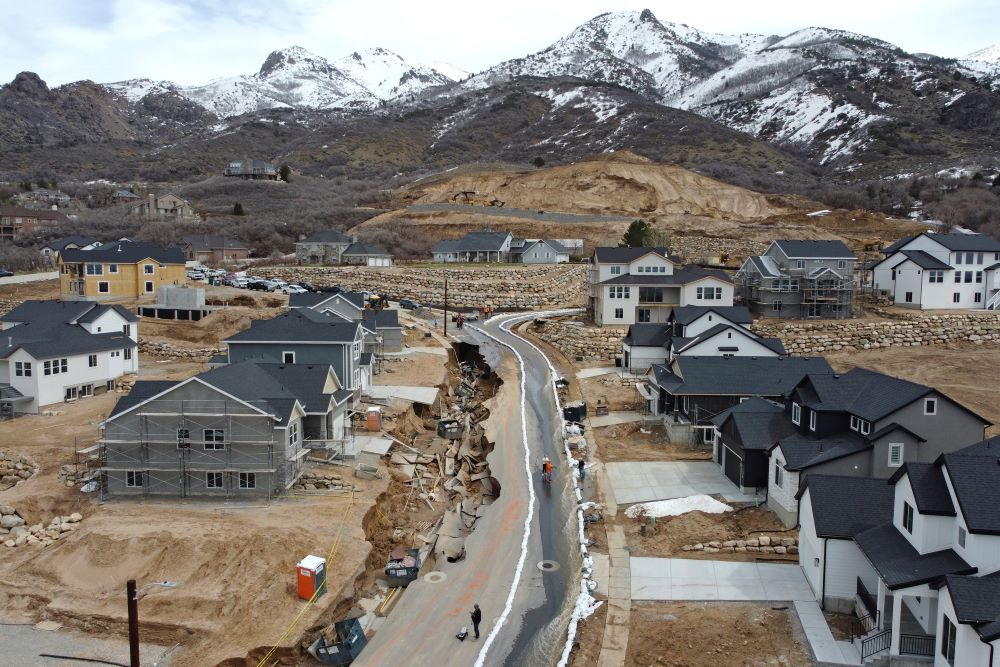 Local officials issued evacuation orders for at least 20 homes as temperatures spiked and snowmelt coursed through the streets on Wednesday, April 12, 2023, in Kaysville, Utah. (AP Photo/Rick Bowmer)