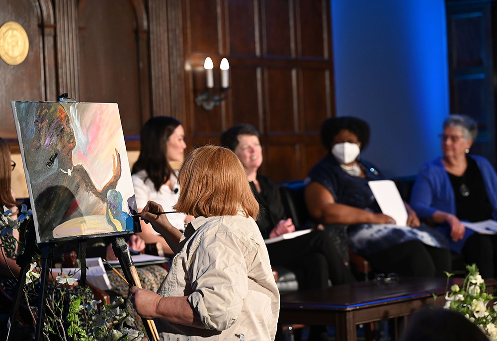 St. Joseph Sr. Celeste Mokrzycki, the chaplain for the School of Nursing and the School of Health at Georgetown, paints during the April 17 event on "Faith, Feminism, and Being Unfinished: The Question of Women's Ordination" at Georgetown University. (Courtesy of Georgetown University/Leslie E. Kossoff)