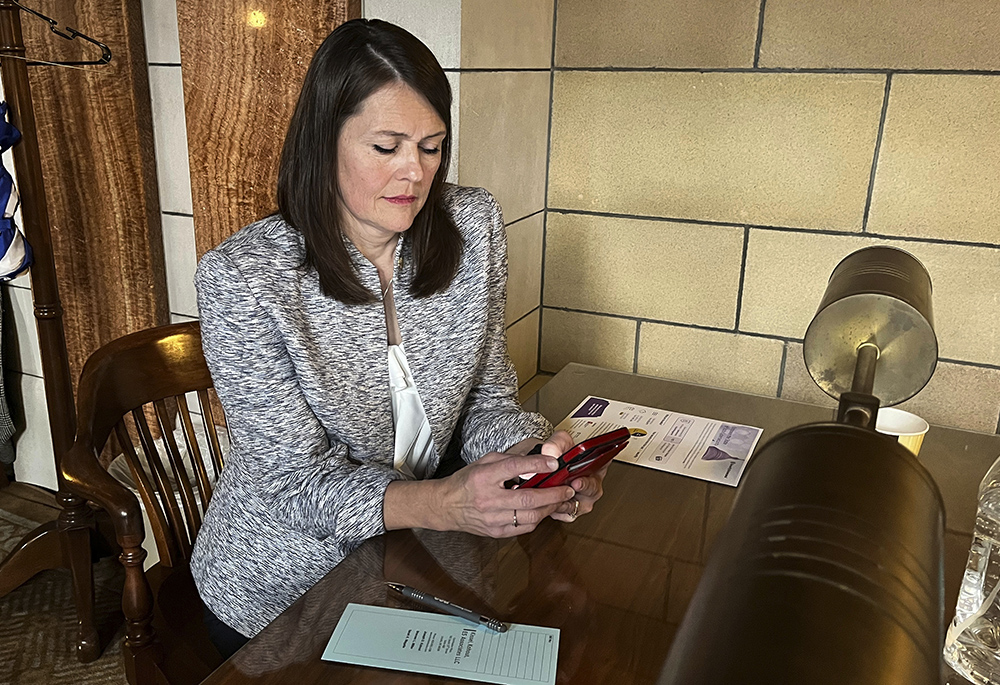 Nebraska state Sen. Kathleen Kauth works inside the Nebraska legislative chamber March 23 in Lincoln, Nebraska, as her bill, which would ban gender-affirming care for anyone 18 and younger in the state, was debated. (AP photo/Margery Beck, file)