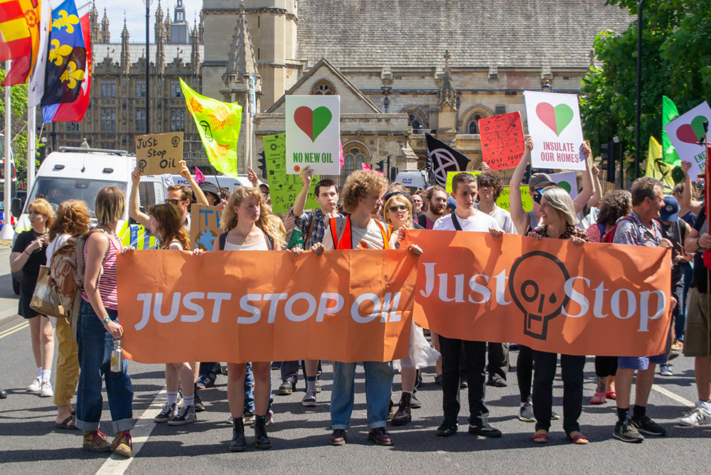 Protesters against climate change and the fossil fuel industry march in Parliament Square in London July 23, 2022. (Dreamstime/Jessica Girvan)