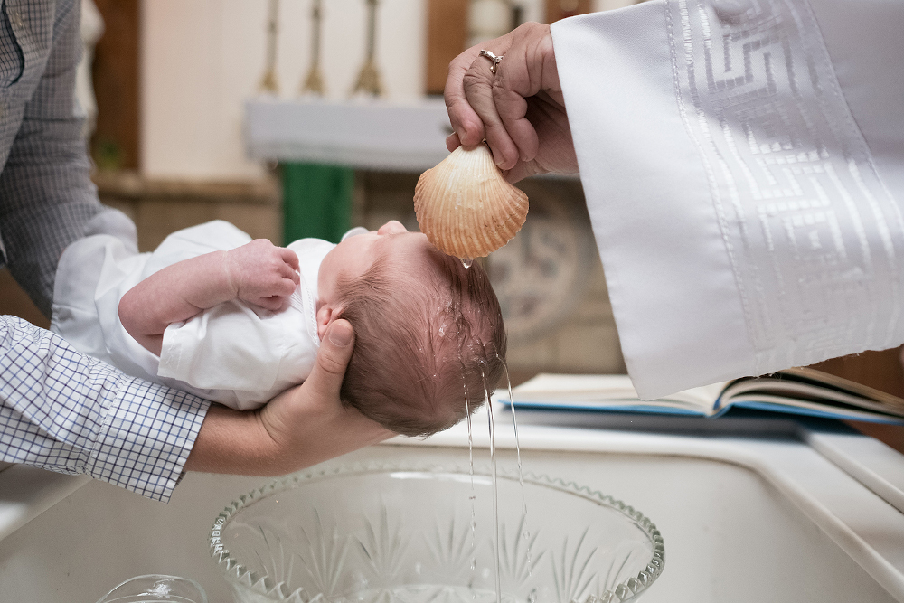 An infant being baptized. (Unsplash/Josh Applegate)