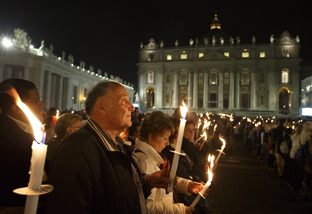 The faithful attend a candlelight vigil in St. Peter's Square at the Vatican Oct. 11, 2012, to mark the 50th anniversary of the opening of the Second Vatican Council. (CNS/Paul Haring)