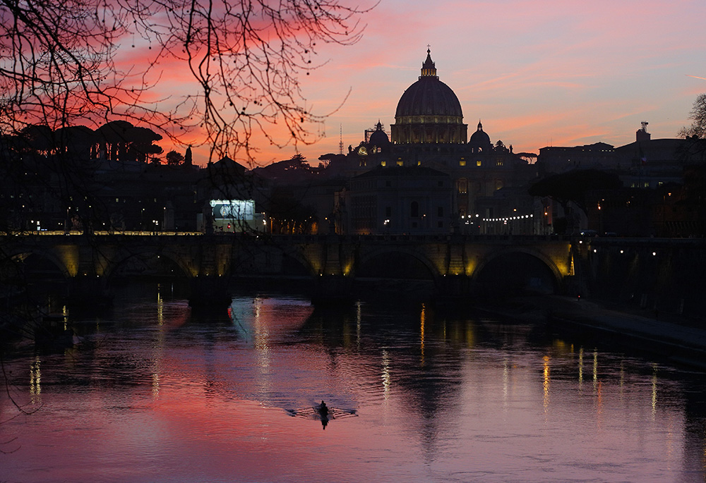 St. Peter's Basilica is seen across the Tiber River March 5, 2019, as the sun sets in Rome. (CNS/Paul Haring)