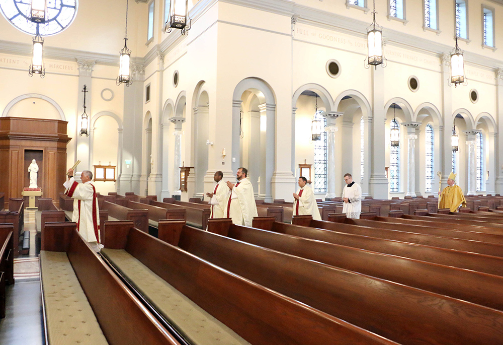 Bishop Richard Stika of the Diocese of Knoxville, Tennessee, far right, processes into the Cathedral of the Most Sacred Heart of Jesus at the beginning of Easter Mass April 12, 2020. (CNS/The East Tennessee Catholic/Bill Brewer)