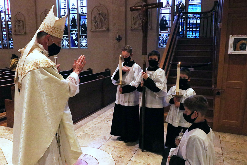 Archbishop Alexander Sample of Portland, Oregon, blesses altar servers after the Mass for the feast of St. Joseph March 19, 2021, at St. Mary's Cathedral of the Immaculate Conception in Portland. (CNS/Catholic Sentinel/Ed Langlois)